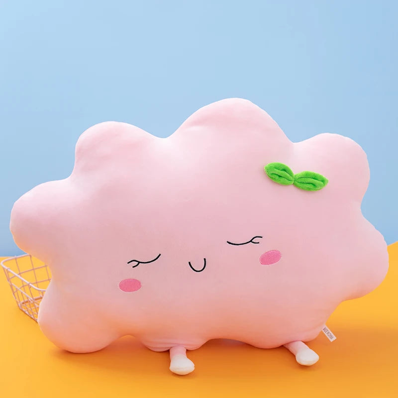 Plush flower and heart-shaped pillows arranged on a pastel bed setup