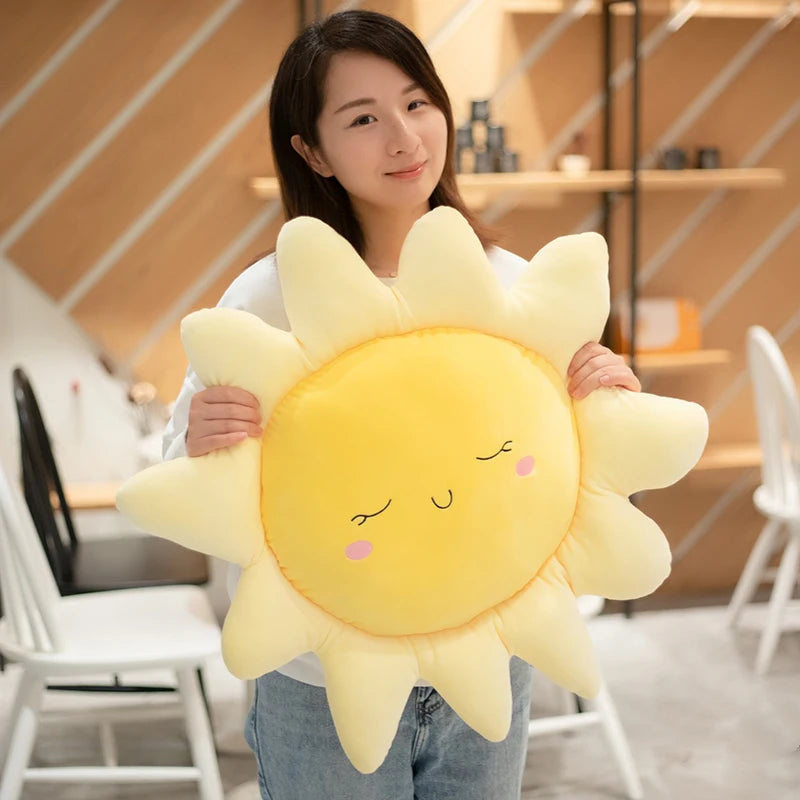 Plush flower and heart-shaped pillows arranged on a pastel bed setup