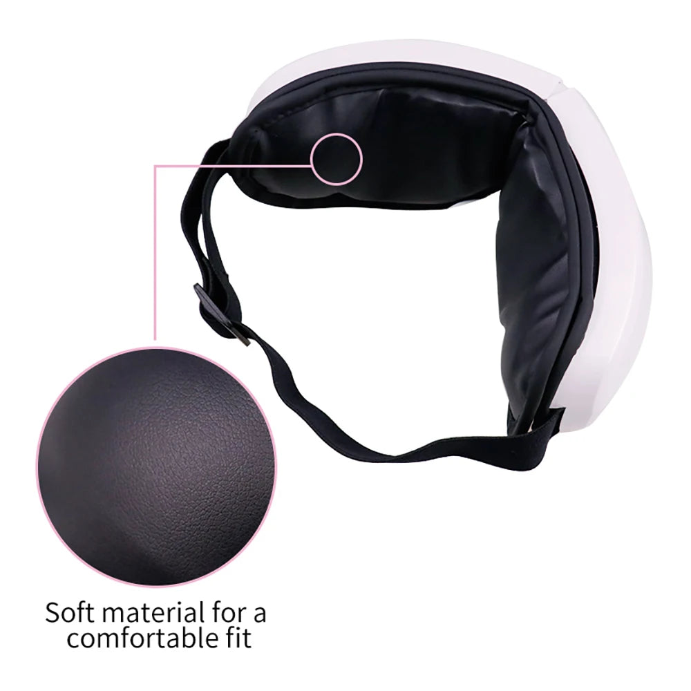 Smart eye massager with built-in controls resting on a table, showing soft lining and adjustable strap