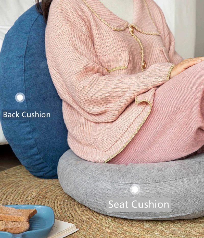 Neutral-colored floor seat cushion placed on a rug in a minimalist room setting