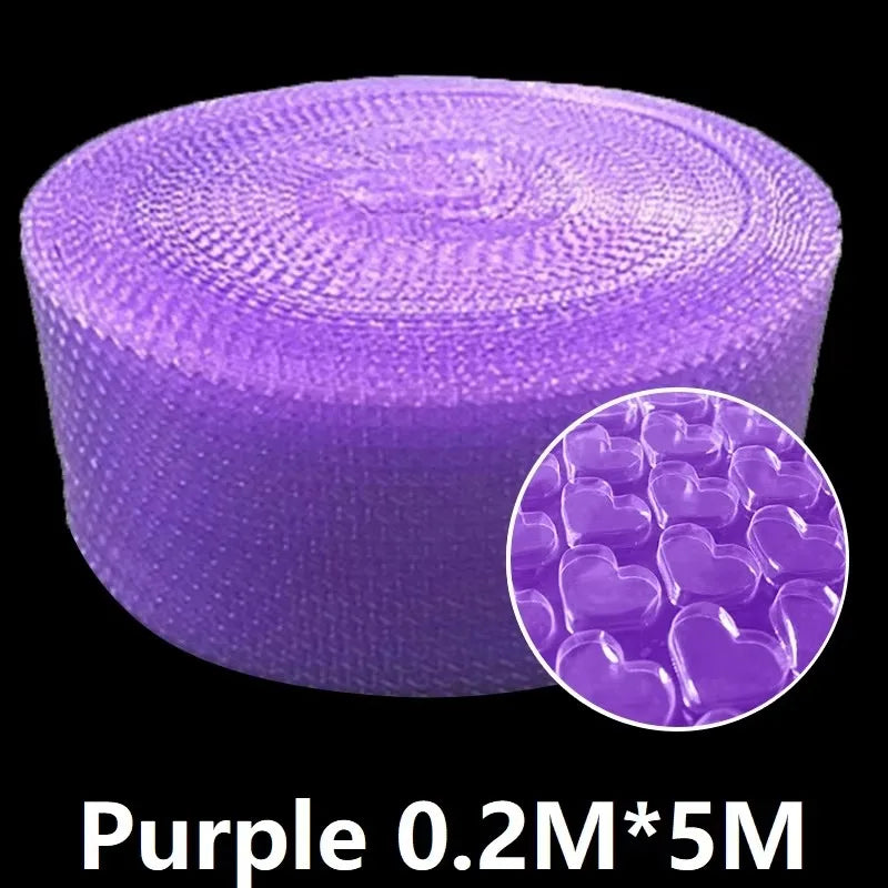 Hands popping bubble paper roll laid out on a desk in a relaxed workspace