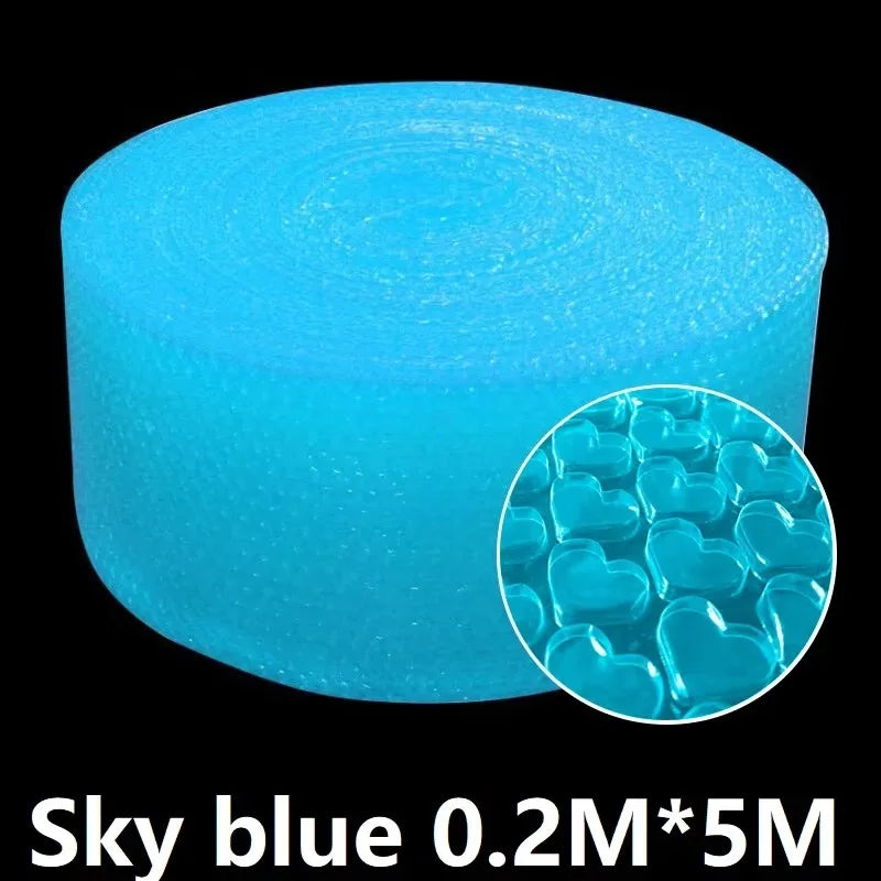 Hands popping bubble paper roll laid out on a desk in a relaxed workspace