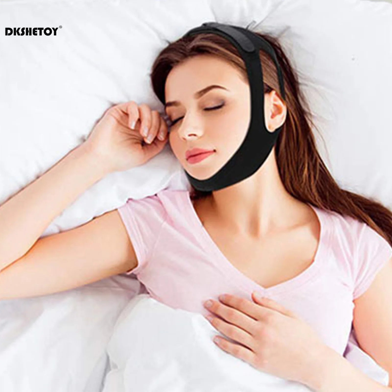 Person wearing anti-snoring chin strap while lying in bed, shown from the side