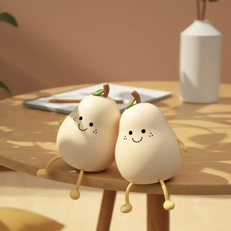 Pear-shaped silicone night light glowing softly on a bedside table in a child’s room