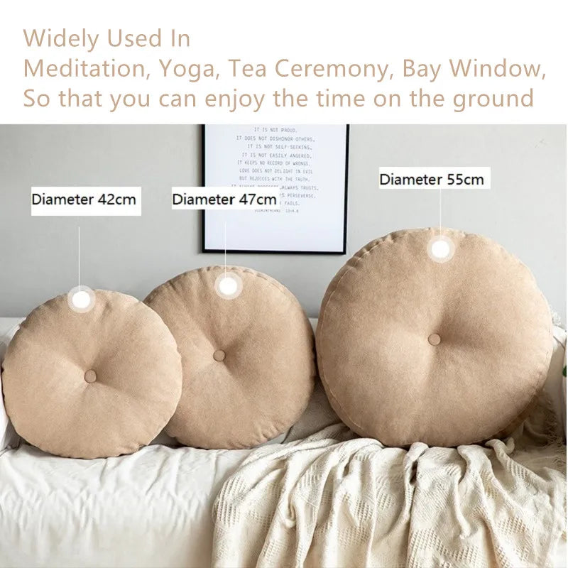 Neutral-colored floor seat cushion placed on a rug in a minimalist room setting