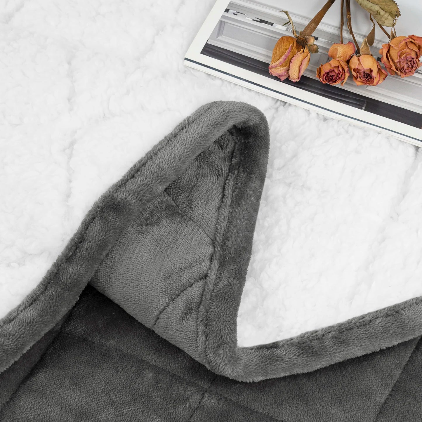 Weighted blanket draped over a bed with soft lighting, creating a cozy and calming atmosphere
