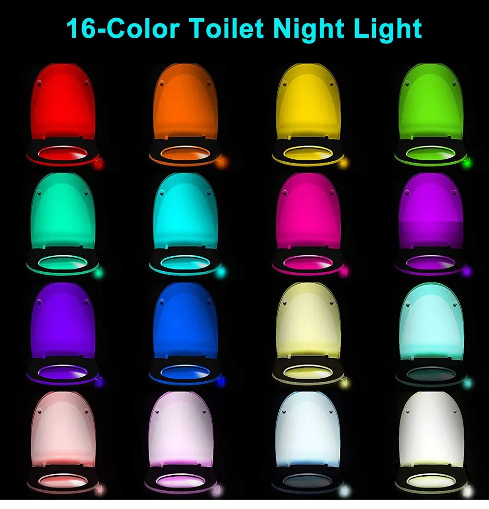 LED toilet night light glowing in soft colors attached to toilet bowl in a dark bathroom
