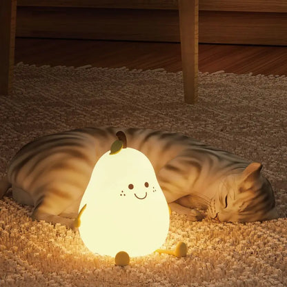 Pear-shaped silicone night light glowing softly on a bedside table in a child’s room
