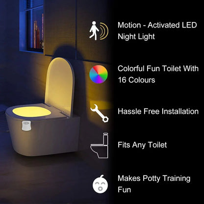 LED toilet night light glowing in soft colors attached to toilet bowl in a dark bathroom
