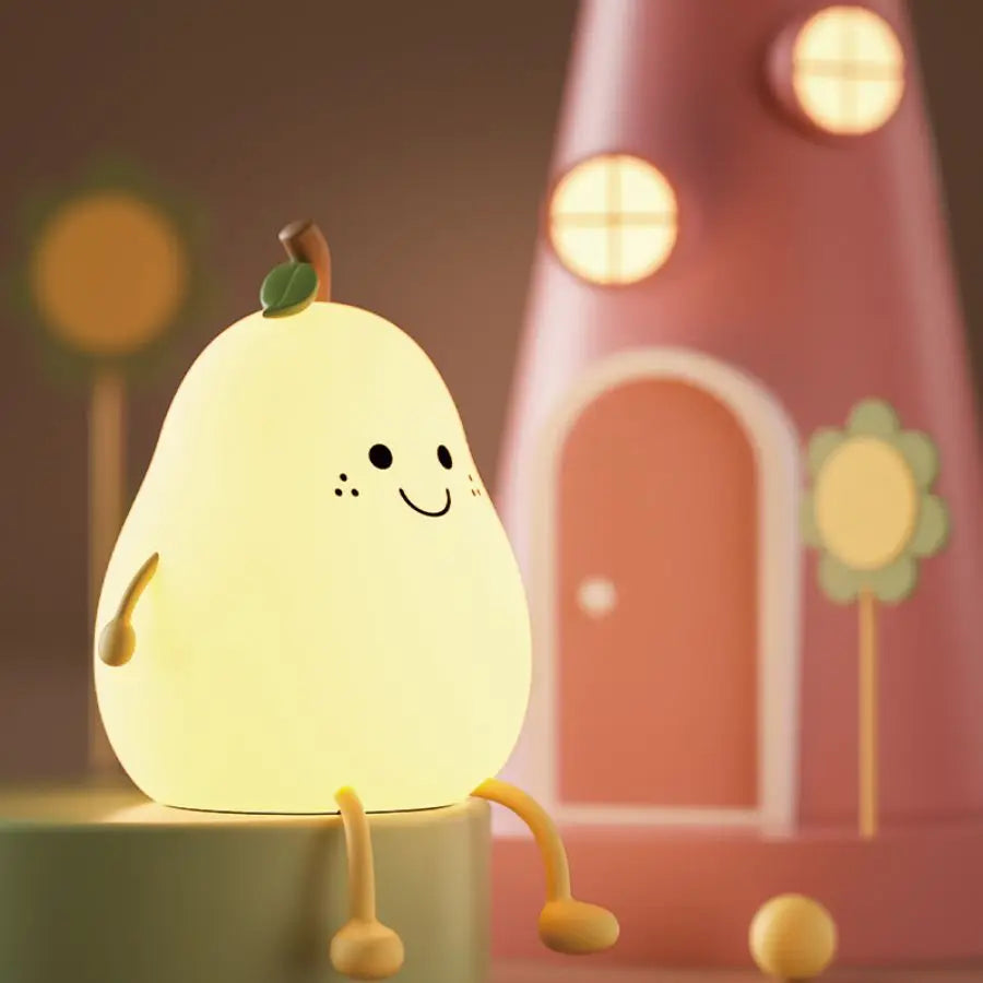 Pear-shaped silicone night light glowing softly on a bedside table in a child’s room
