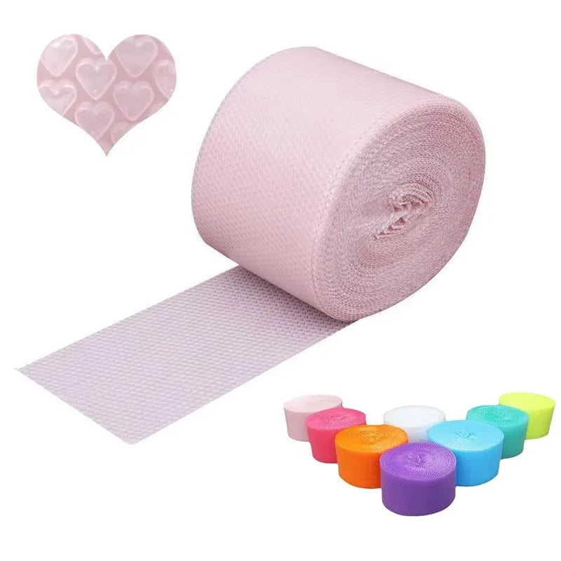 Hands popping bubble paper roll laid out on a desk in a relaxed workspace

