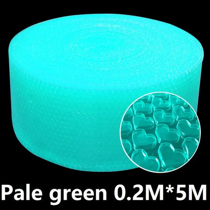 Hands popping bubble paper roll laid out on a desk in a relaxed workspace
