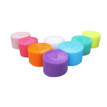 Hands popping bubble paper roll laid out on a desk in a relaxed workspace
