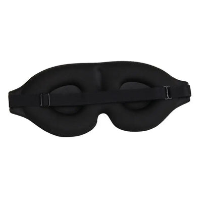 3D contoured sleep mask resting on a pillow, showing raised eye cups and soft material
