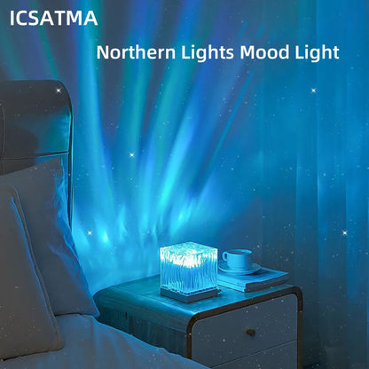 Northern lights projector casting green and blue aurora effects with stars on a dark ceiling
