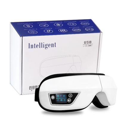 Smart eye massager with built-in controls resting on a table, showing soft lining and adjustable strap
